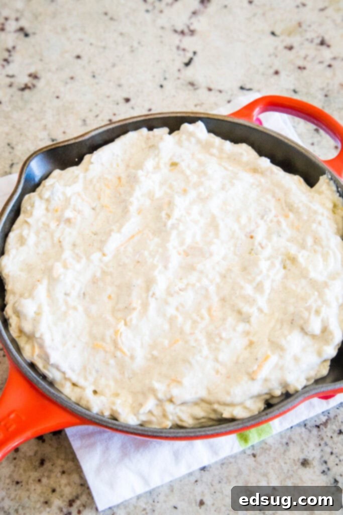 Southwest Green Chile Chicken Enchilada Dip 4 Green Chili Chicken Enchilada Dip in a baking dish, perfectly baked with melted cheese and ready to be served.