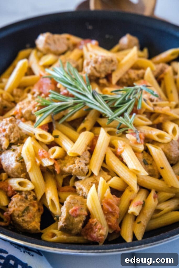 skillet with creamy sausage penne pasta ready to serve