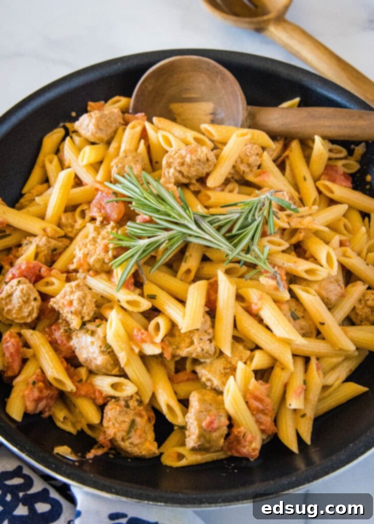 overhead view of a skillet with creamy penne and sausage