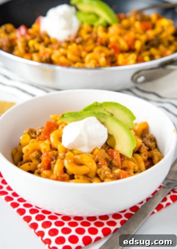 Fiesta Taco Pasta Skillet 3 taco pasta skillet with avocado and sour cream in a white bowl