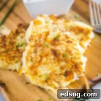 Crispy Golden Cauliflower Fritters 2 Close up of two cauliflower fritters in a stack, next to a fork