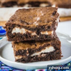 cropped close up stacked peppermint patty brownies on a white plate