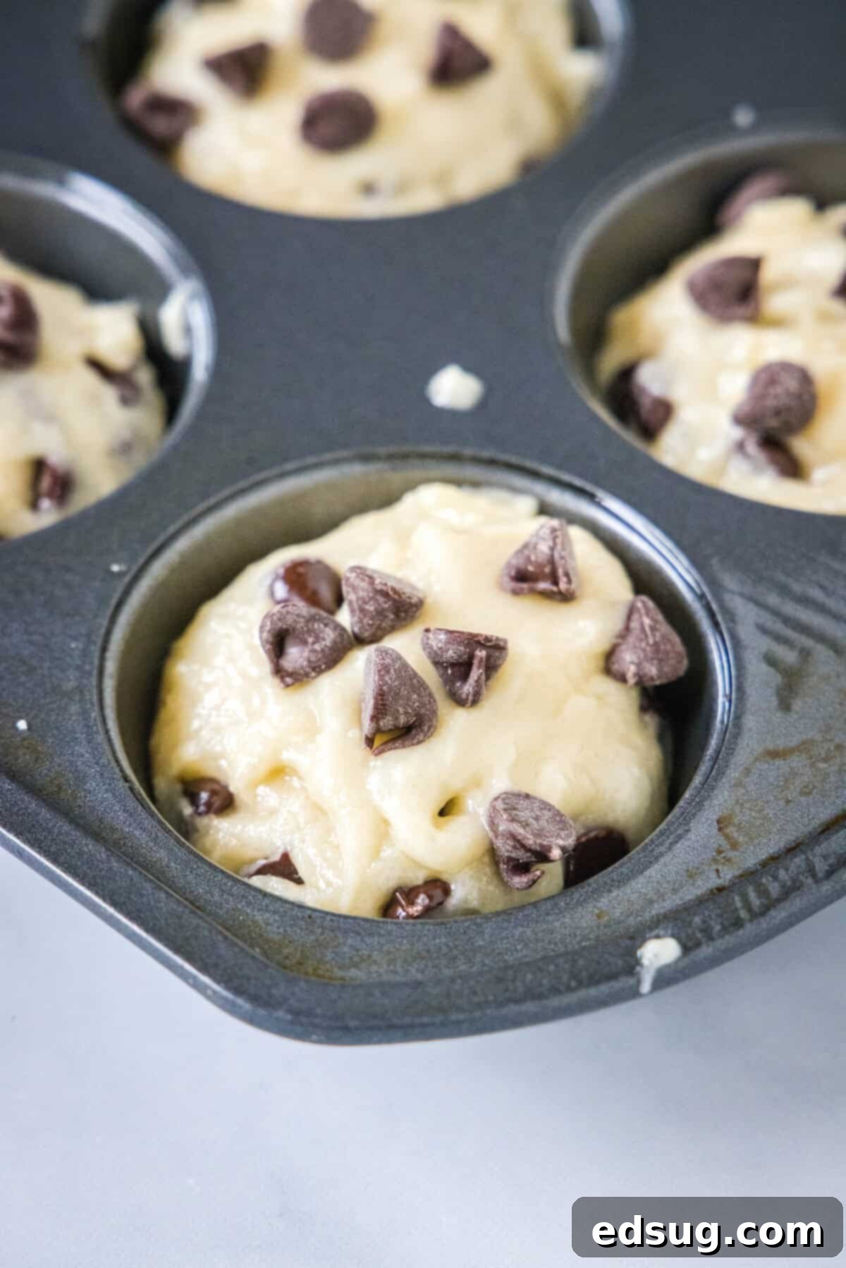 Irresistible Chocolate Chip Muffins 4 muffin batter in a muffin pan