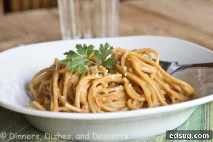 Bowl of Asian Peanut Noodles topped with sesame seeds