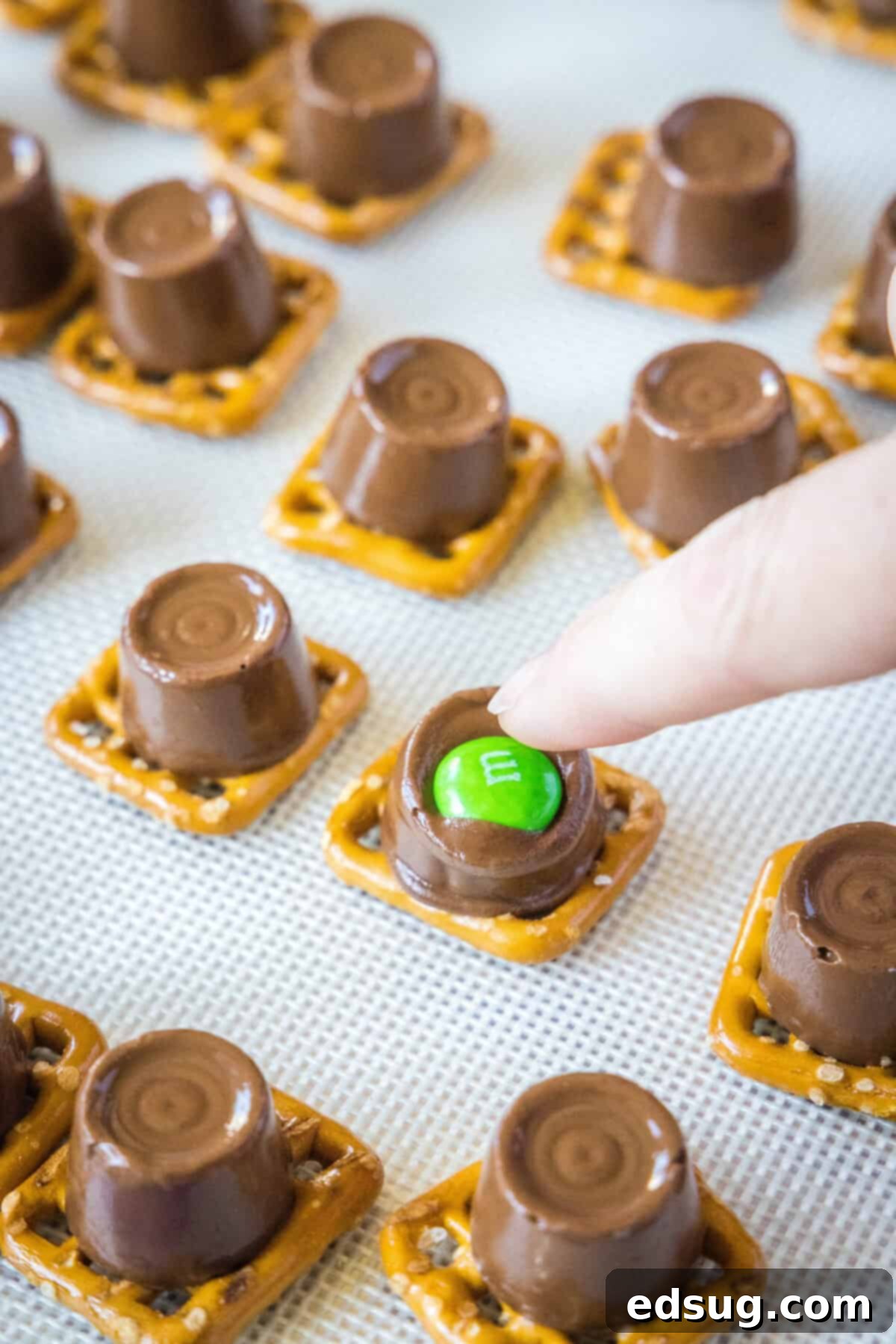 topping rolo pretzels with M&M